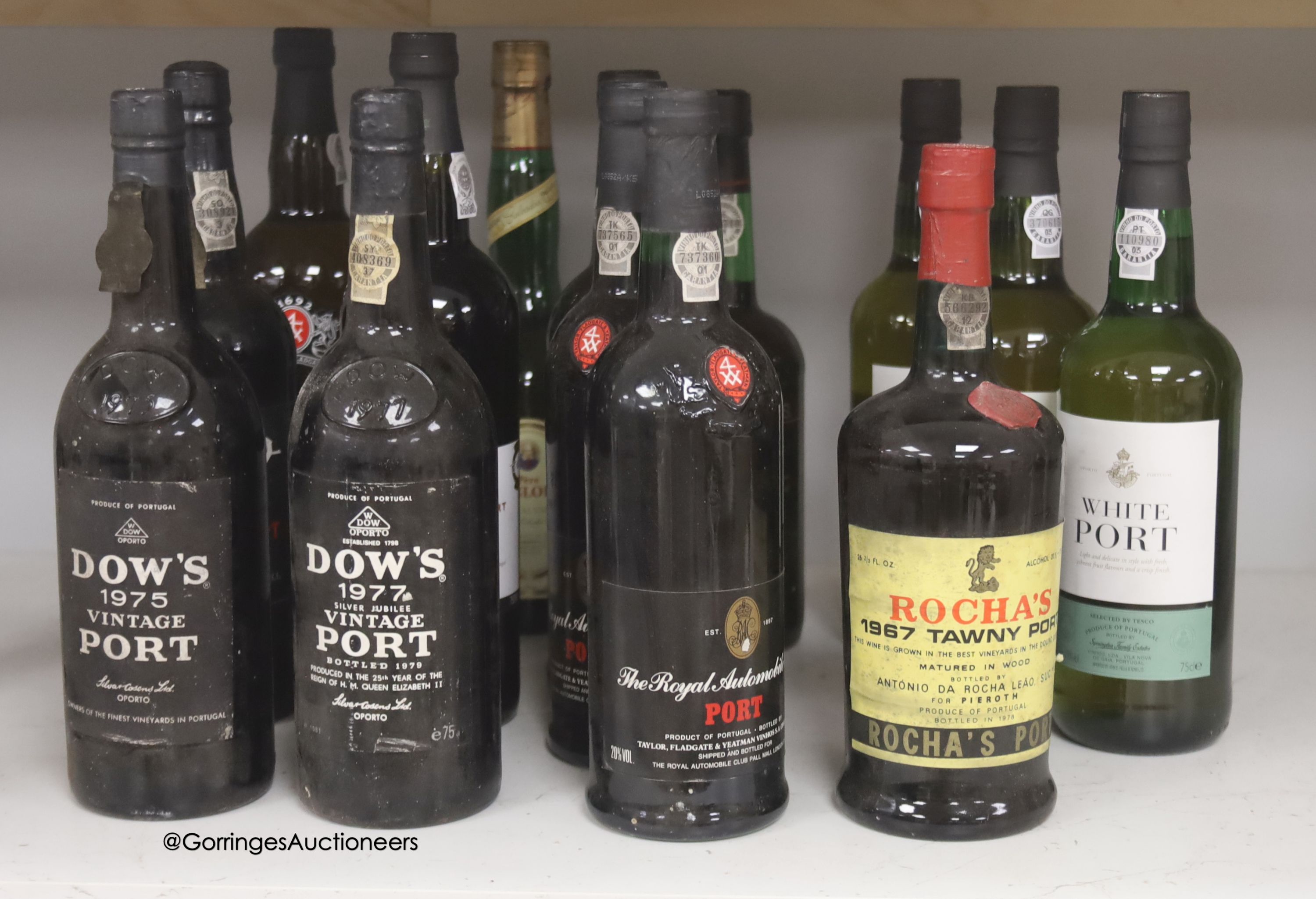 Thirteen assorted bottles of Port including Dow's 1975 and 1977 and one bottle of Magloire Calvados